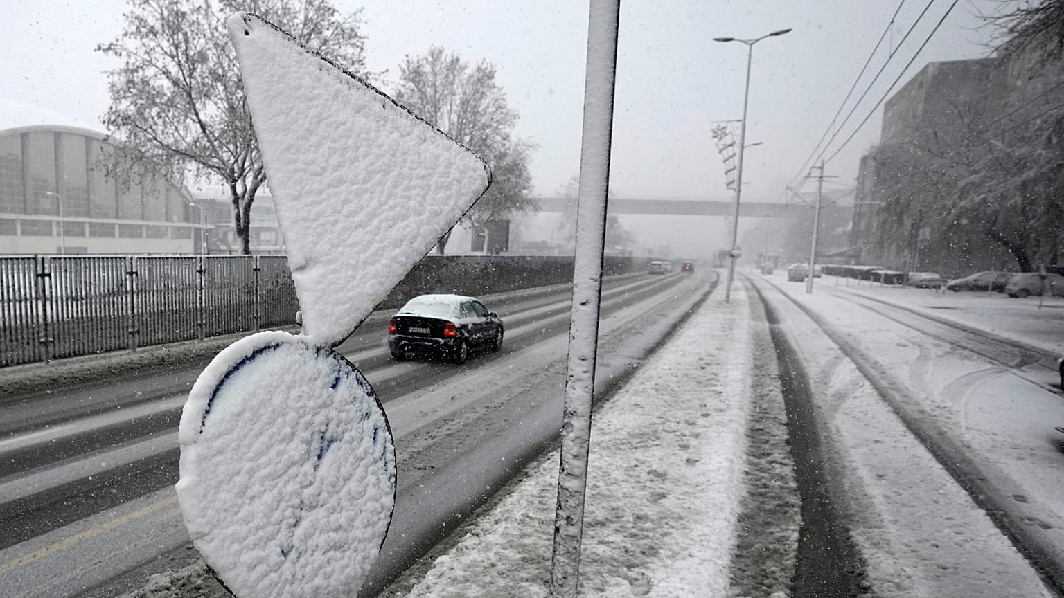 Cars on the street during snow storm in Belgrade, Serbia, Sunday, Dec. 12, 2021. 
