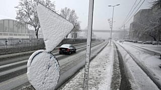 Cars on the street during snow storm in Belgrade, Serbia, Sunday, Dec. 12, 2021. 