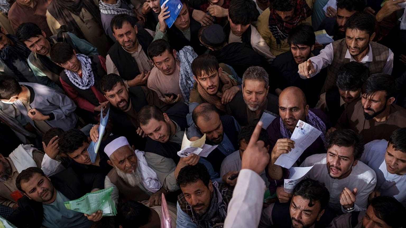 People gather outside a government passport office