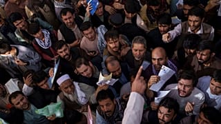 People gather outside a government passport office