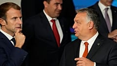 French President Emmanuel Macron, left, speaks with Hungary's Prime Minister Viktor Orban, second right, at an EU summit  in Kranj, Slovenia, Oct. 6, 2021. 