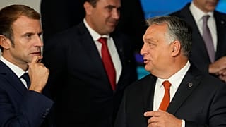 French President Emmanuel Macron, left, speaks with Hungary's Prime Minister Viktor Orban, second right, at an EU summit  in Kranj, Slovenia, Oct. 6, 2021. 