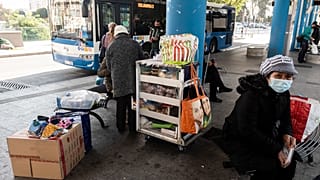 People with face masks waiting for the bus in old Nicosia