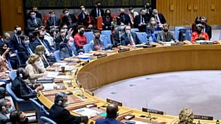 Russian Ambassador Vassily Nebenzia, upper left, raises his hand to veto a U.N. Security Council resolution casting climate change as a threat to global peace, Dec. 13, 2021.