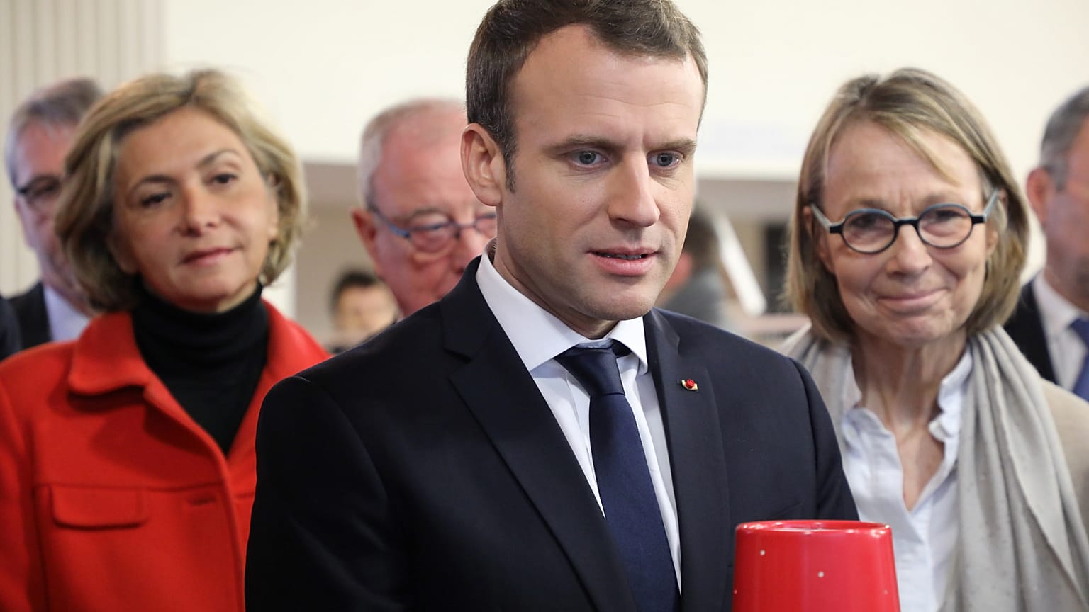 French President Emmanuel Macron, and Ile-de-France regional council president Valerie Pecresse (L), visits Les Mureaux, outside Paris, Feb. 20, 2018.