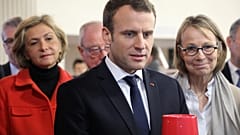 French President Emmanuel Macron, and Ile-de-France regional council president Valerie Pecresse (L), visits Les Mureaux, outside Paris, Feb. 20, 2018.