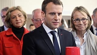 French President Emmanuel Macron, and Ile-de-France regional council president Valerie Pecresse (L), visits Les Mureaux, outside Paris, Feb. 20, 2018.
