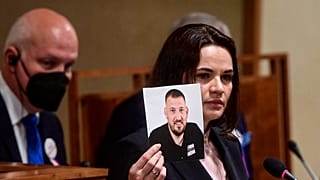Светлана Тихановская держит в руках фотографию мужа Сергея Тихановского. 
