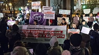 People hold banners against domestic violence during a 2019 rally in downtown Moscow.