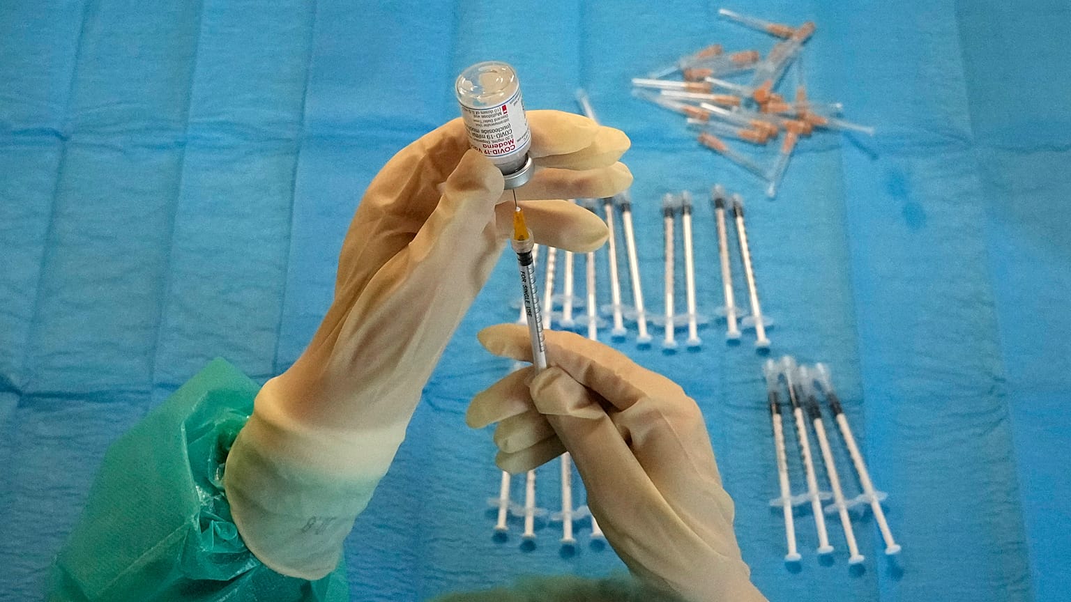 A medical nurse prepares a Moderna vaccination against COVID-19 in a vaccination center set up in a gym of a police barracks in Rome, Dec. 10, 2021. 