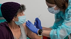 A resident of Warsaw receives a booster shot against COVID-19, in Warsaw, Poland, Tuesday Dec. 7, 2021.