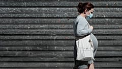 A pregnant woman walks in the streets in Paris on May 12, 2020 .