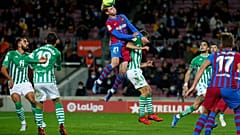 Barcelona's Frenkie de Jong, top, goes for a header with Sergio Canales at a match between Barcelona and Real Betis at Camp Nou 