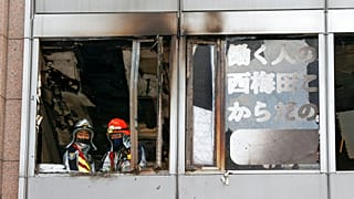 Pompier japonais à la fenêtre de l'étage de l'immeuble incendié, Osaka, Japon, 17 décembre 2021 