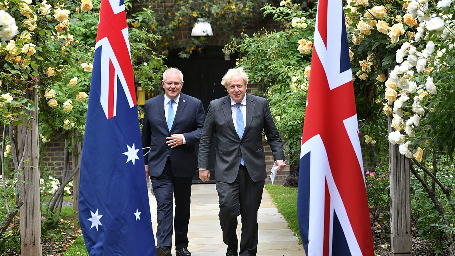 Britain's Prime Minister Boris Johnson, right, walks with Australian Prime Minister Scott Morrison after their meeting, in the garden of 10 Downing Street, June 15, 2021. 