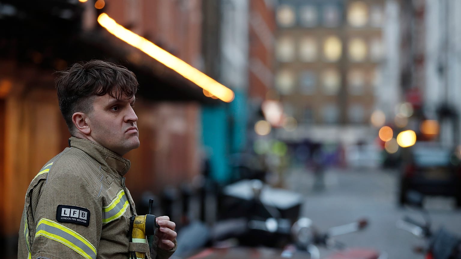 A firefighter stands in a blocked a street in the Soho area of London, Feb. 3, 2020. 