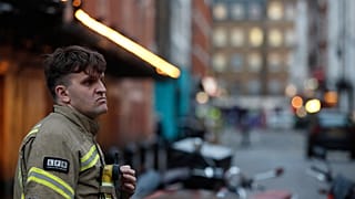 A firefighter stands in a blocked a street in the Soho area of London, Feb. 3, 2020. 