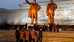 Citizens visit the bronze statues of their late leaders Kim Il Sung, left, and Kim Jong Il on Mansu Hill in Pyongyang