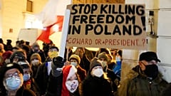 People demonstrate after the Polish parliament approved a bill that is widely viewed as an attack on media freedom, in Warsaw, Poland, Dec. 19, 2021. 