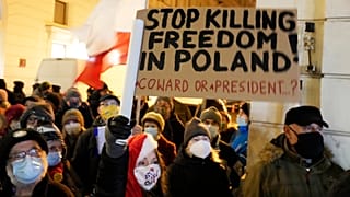 People demonstrate after the Polish parliament approved a bill that is widely viewed as an attack on media freedom, in Warsaw, Poland, Dec. 19, 2021.