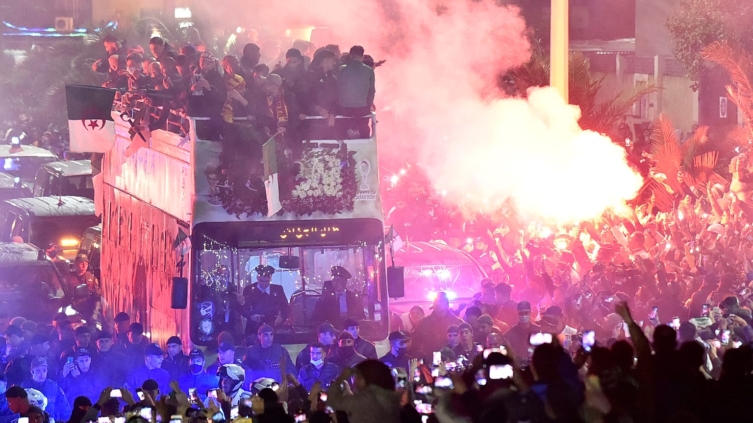 المنتخب الجزائري لكرة القدم على متن حافلة يحتفل مع جماهيره في الجزائر العاصمة بعد يوم من فوزه بكأس العرب لكرة القدم 2021.