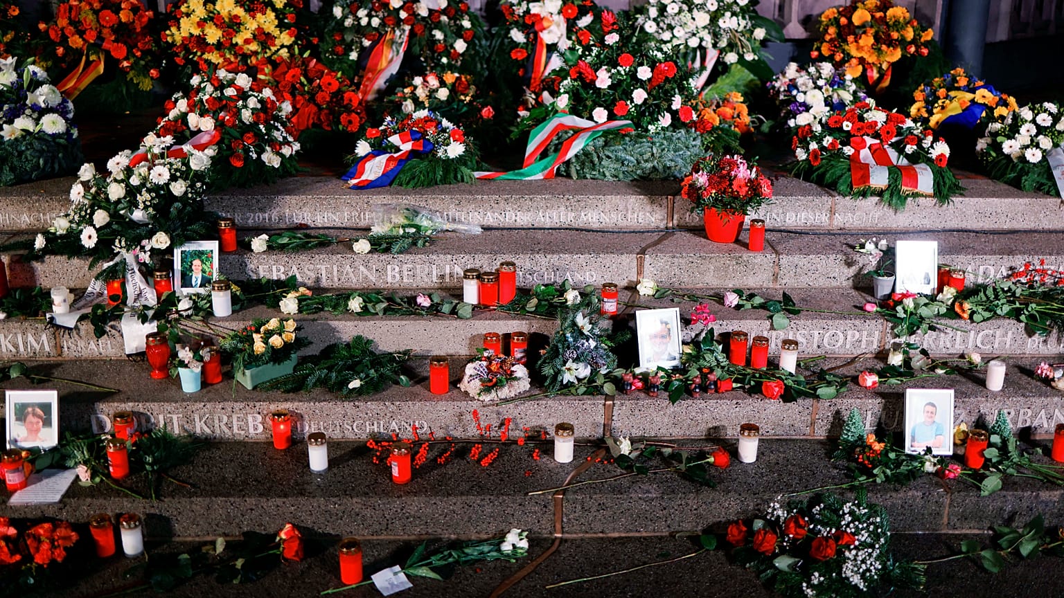Flowers, candles and wreaths left at the memorial "Der Riss" commemorating the victims of the 2016 terrorist attack at Breitscheidplatz square in Berlin, on Dec. 19, 2021.