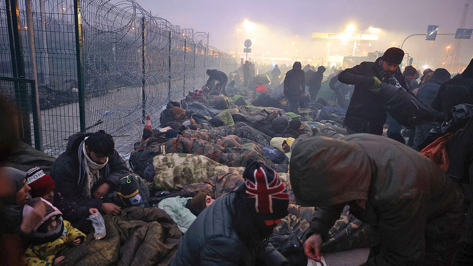Migrants from the Middle East and elsewhere gather at the checkpoint "Kuznitsa" at the Belarus-Poland border near Grodno, Belarus, on Monday, Nov. 15, 2021.