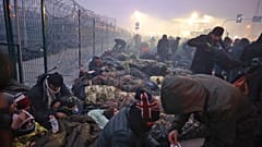 Migrants from the Middle East and elsewhere gather at the checkpoint "Kuznitsa" at the Belarus-Poland border near Grodno, Belarus, on Monday, Nov. 15, 2021.