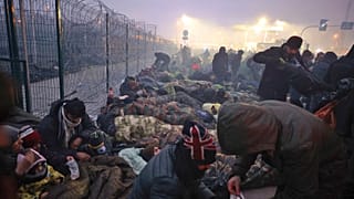 Migrants from the Middle East and elsewhere gather at the checkpoint "Kuznitsa" at the Belarus-Poland border near Grodno, Belarus, on Monday, Nov. 15, 2021.