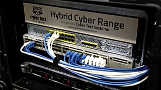 Cables are plugged into a device by Cyber Test Systems at the Cybersecurity Conference in Lille.