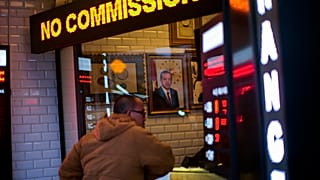 A portrait of Turkey's President Recep Tayyip Erdogan hangs in a money exchange shop in Istanbul, Turkey, Monday, Dec. 20, 2021.