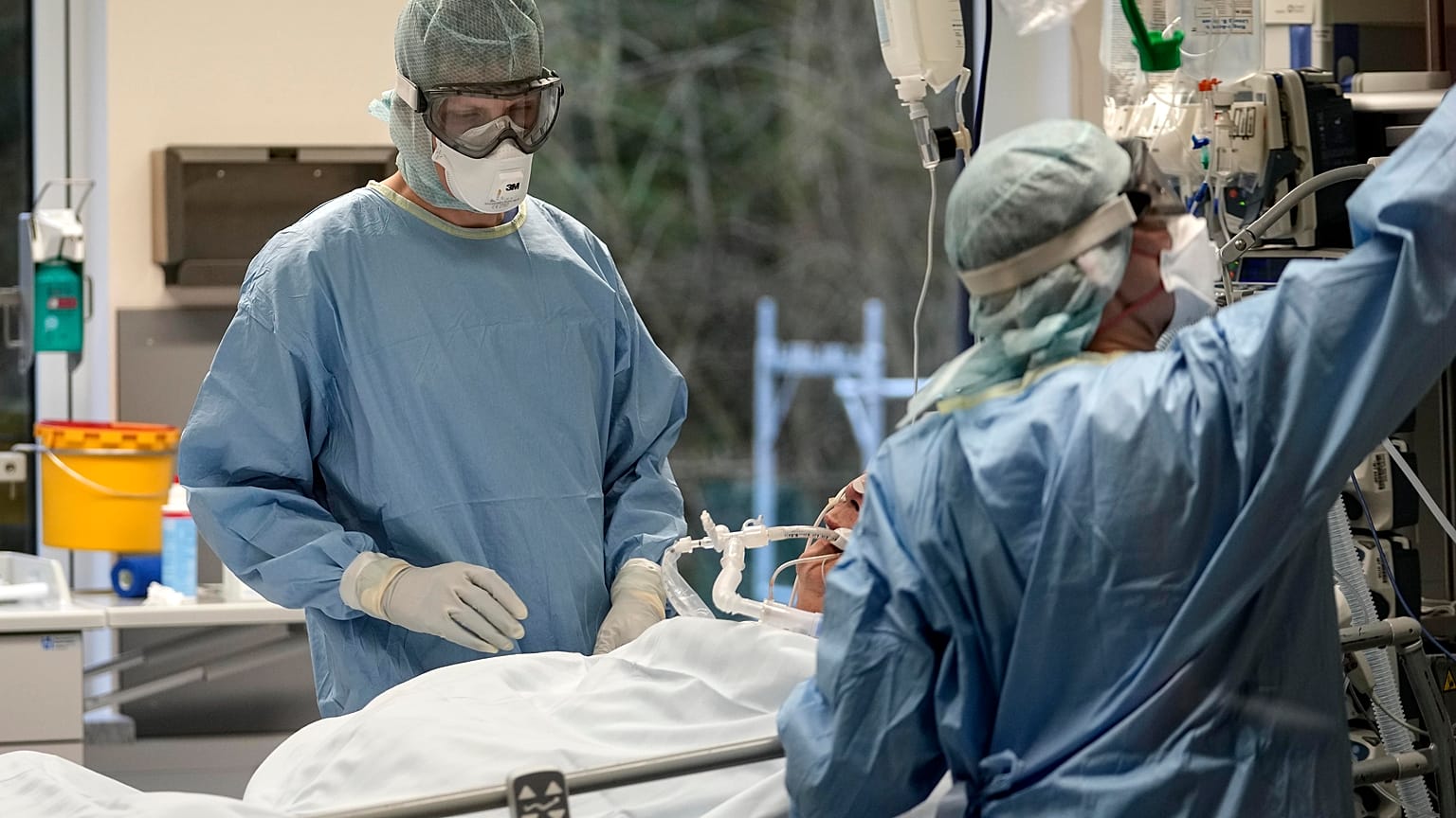 An intubated COVID-19 patient gets treatment at the intensive care unit at the Westerstede Clinical Center, in Westerstede, northwest Germany, Dec. 17, 2021. 