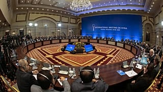 Syrian regime representatives and opposition delegates along with other attendees take part in the session of Syria peace talks in Astana on December 22, 2017.