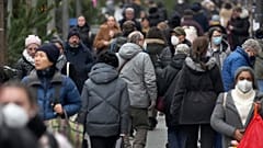 People walk on a shopping road in Berlin, Germany, Tuesday, Dec. 21, 2021