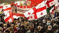 Georgian opposition demonstrators attend a rally in support of former President Mikheil Saakashvili in Tbilisi, Georgia, Tuesday, Dec. 21, 2021.