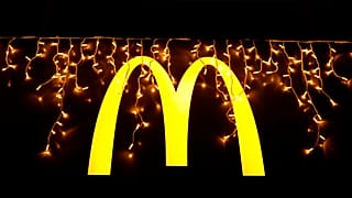 Christmas lights are hung above the logo outside a McDonald's restaurant in Lisbon, Dec. 14, 2021.