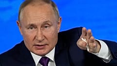 Russian President Vladimir Putin gestures while speaking during his annual news conference in Moscow, Russia, Thursday, Dec. 23, 2021