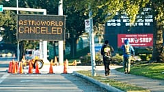 People walk past a sign announcing Astroworld is canceled outside NRG in Houston on Nov. 6, 2021. 