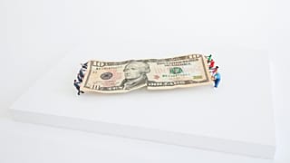 A $10 dollar bill version of the Tug of War.