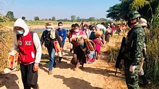 Thai soldiers receive Myanmar villagers arriving in Thailand after fleeing clashes between Myanmar troops and an ethnic Karen rebel group in Mae Sot, Thailand