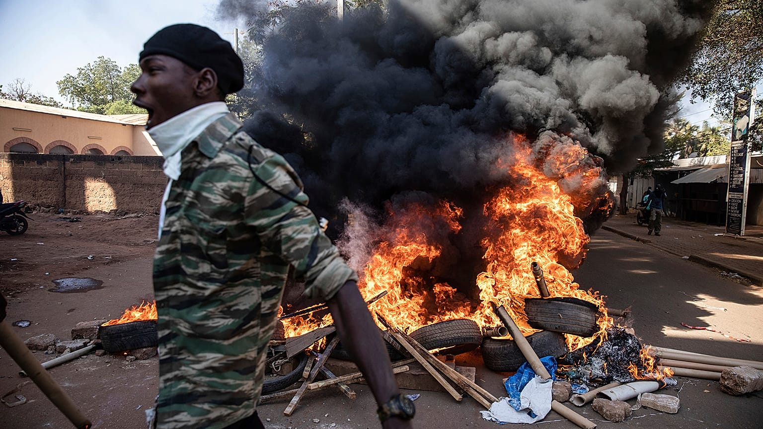 Protestors take to the streets of Burkina Faso's capital Ouagadougou Saturday Nov. 27, 2021, calling for President Roch Marc Christian Kabore to resign