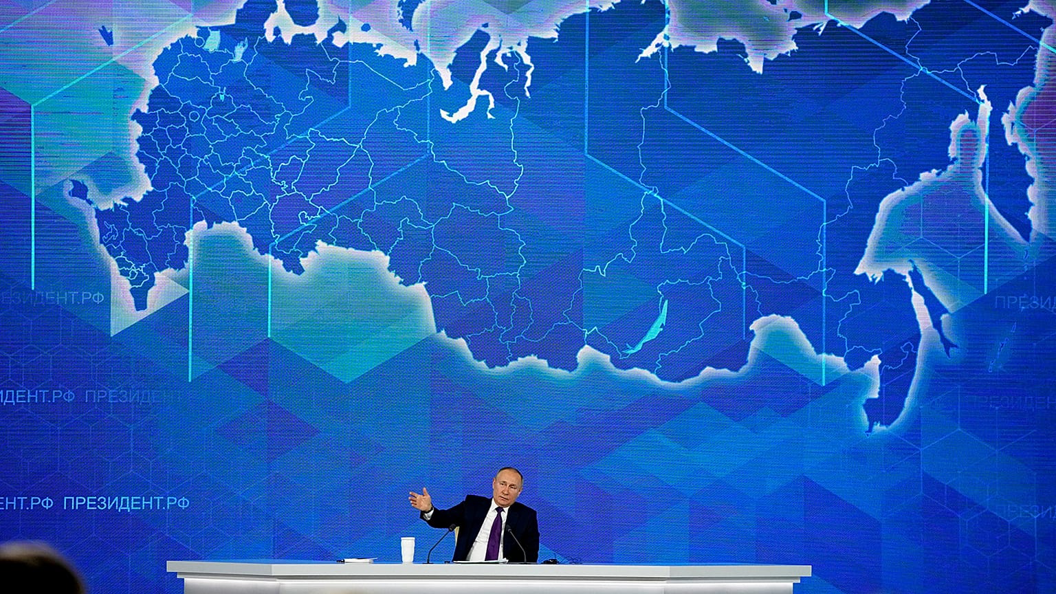Russian President Vladimir Putin gestures while speaking during his annual news conference in Moscow