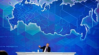 Russian President Vladimir Putin gestures while speaking during his annual news conference in Moscow