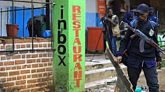 Police officers inspect the scene of a bomb explosion in Beni, eastern Congo 