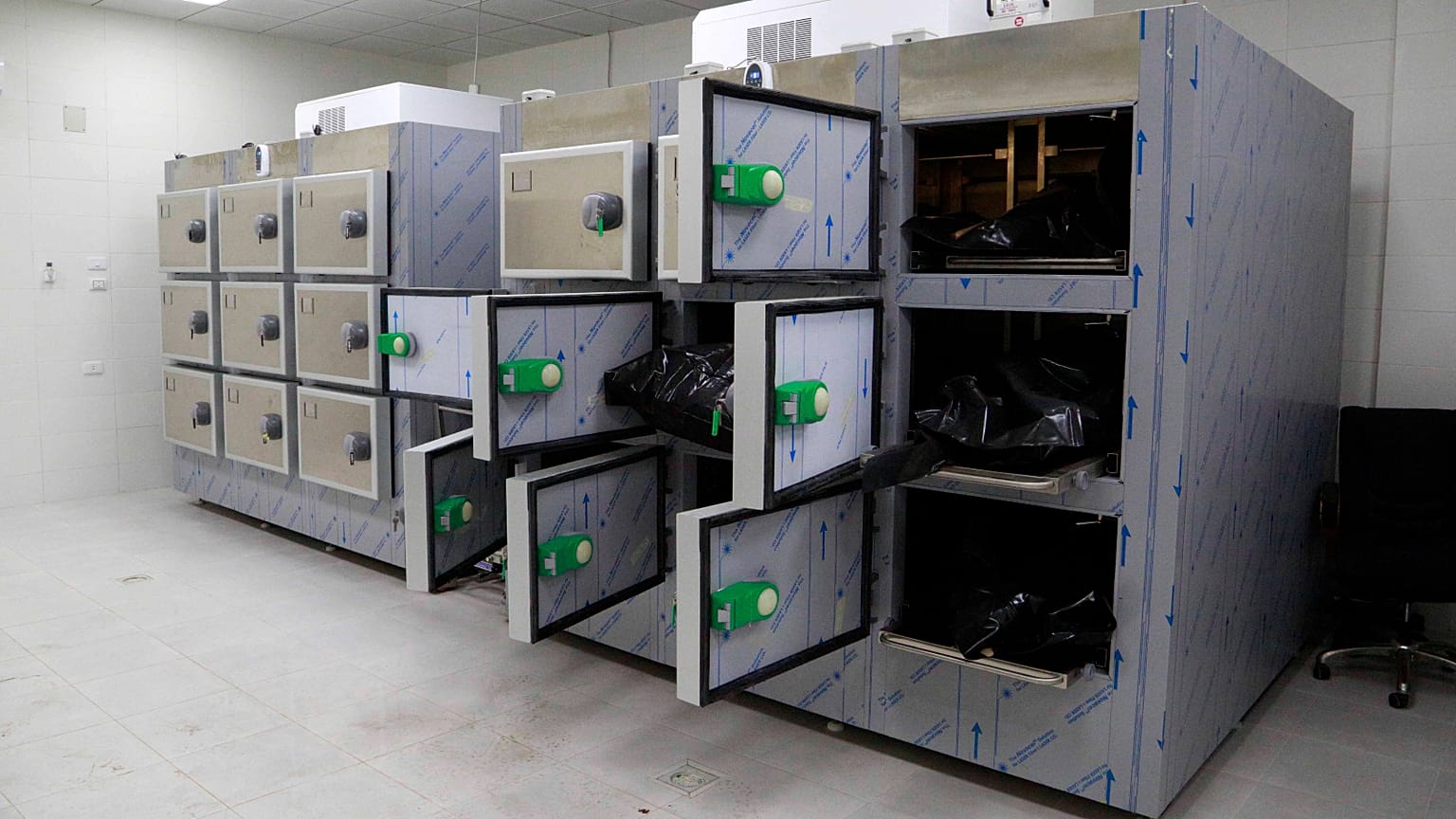 Some of the 28 bodies of migrants that the Libyan Red Crescent said were found late Saturday lie in the mortuary of Khoms City Hospital, in Khoms, Libya, on Dec, 26, 2021. 