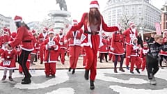 Runners in costumes dancing during warm up