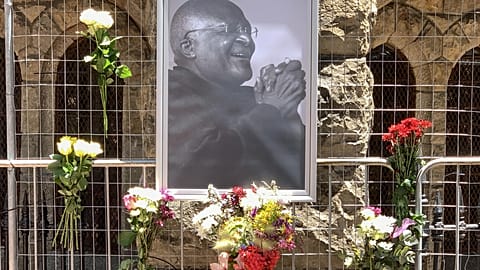 Flowers and a photo of Desmond Tutu 