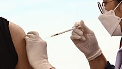 A man receives a Covid-19 coronavirus vaccine at the Bang Sue Central Vaccination Centre in Bangkok 