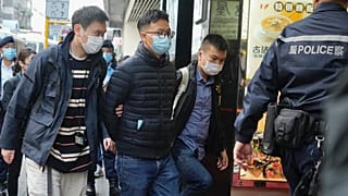 Editor of "Stand News" Patrick Lam, second from left, is arrested by police officers in Hong Kong, Dec. 29, 2021. 