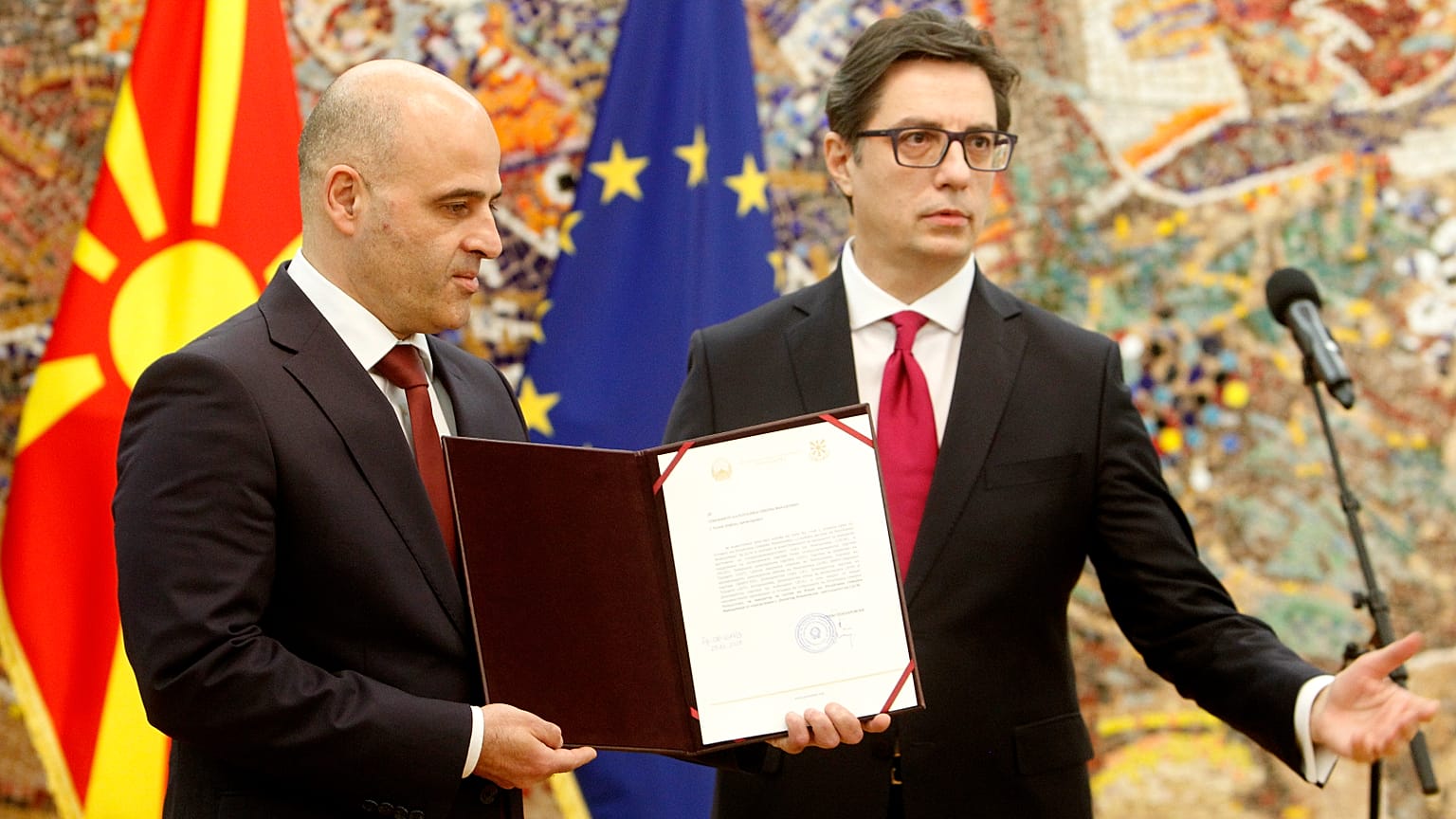 North Macedonia's President Stevo Pendarovski (R), gives a mandate to form a new government to the new country's PM Dimitar Kovacevski (L), in Skopje, Dec. 29, 2021.